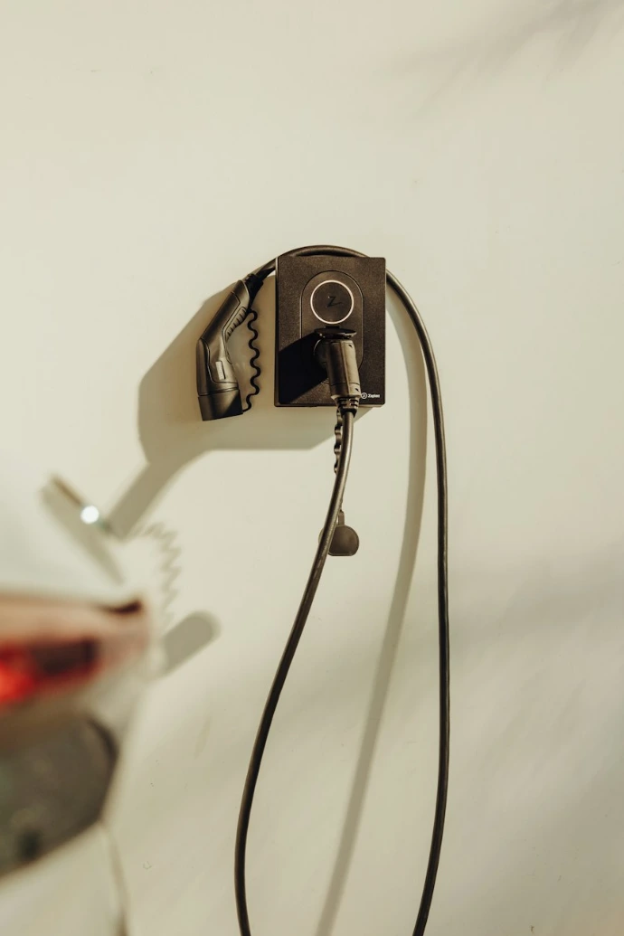 a car plugged into a charger on a wall